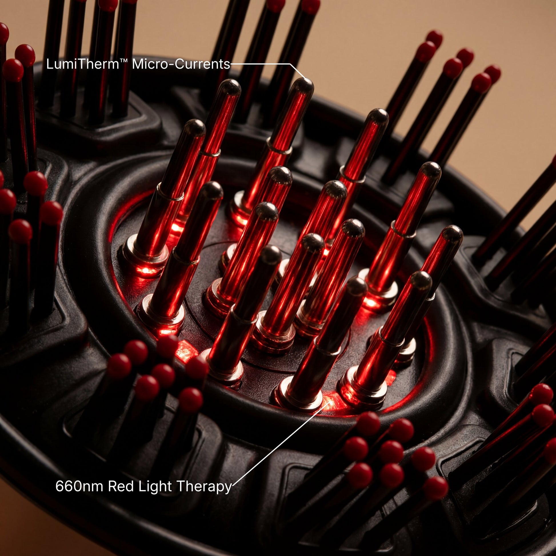 Close-up of a black circular scalp massager with multiple red-tipped micro-current needles and glowing red light therapy elements, with text labels reading 'LumiTherm Micro-Currents' and '660nm Red Light Therapy'.