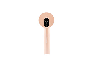 Front profile of the LUXÉRA premium scalp massager in rose gold finish.