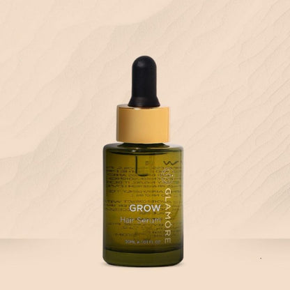 A bottle of GROW Hair Serum with a dropper, labeled for hair care.
