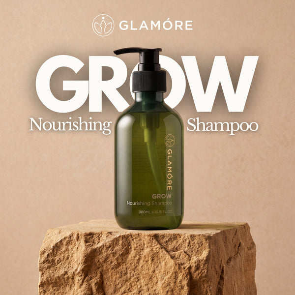 Glamore Grow Nourishing Shampoo bottle on a stone platform with a beige background